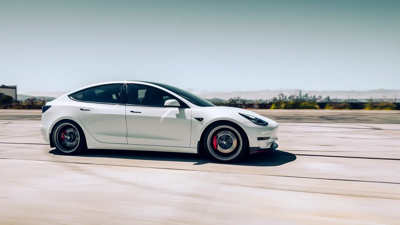 LA, California, USA 2022/4/12 White Model 3 Tesla driving on the road.